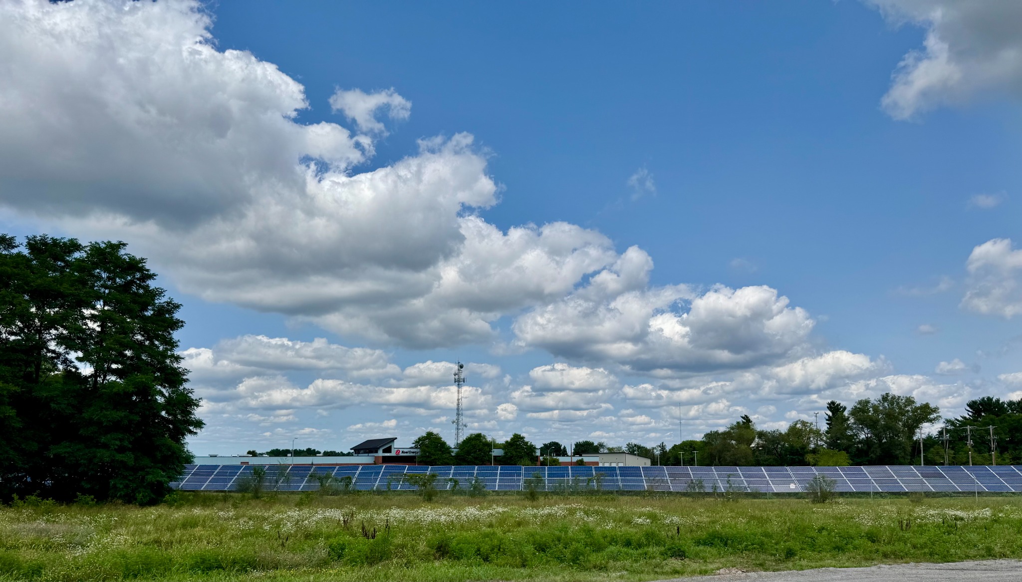 Solar field at the Eau Claire facility beneath a summer sky